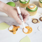 Using edible glue to stick sugarpaste decorations