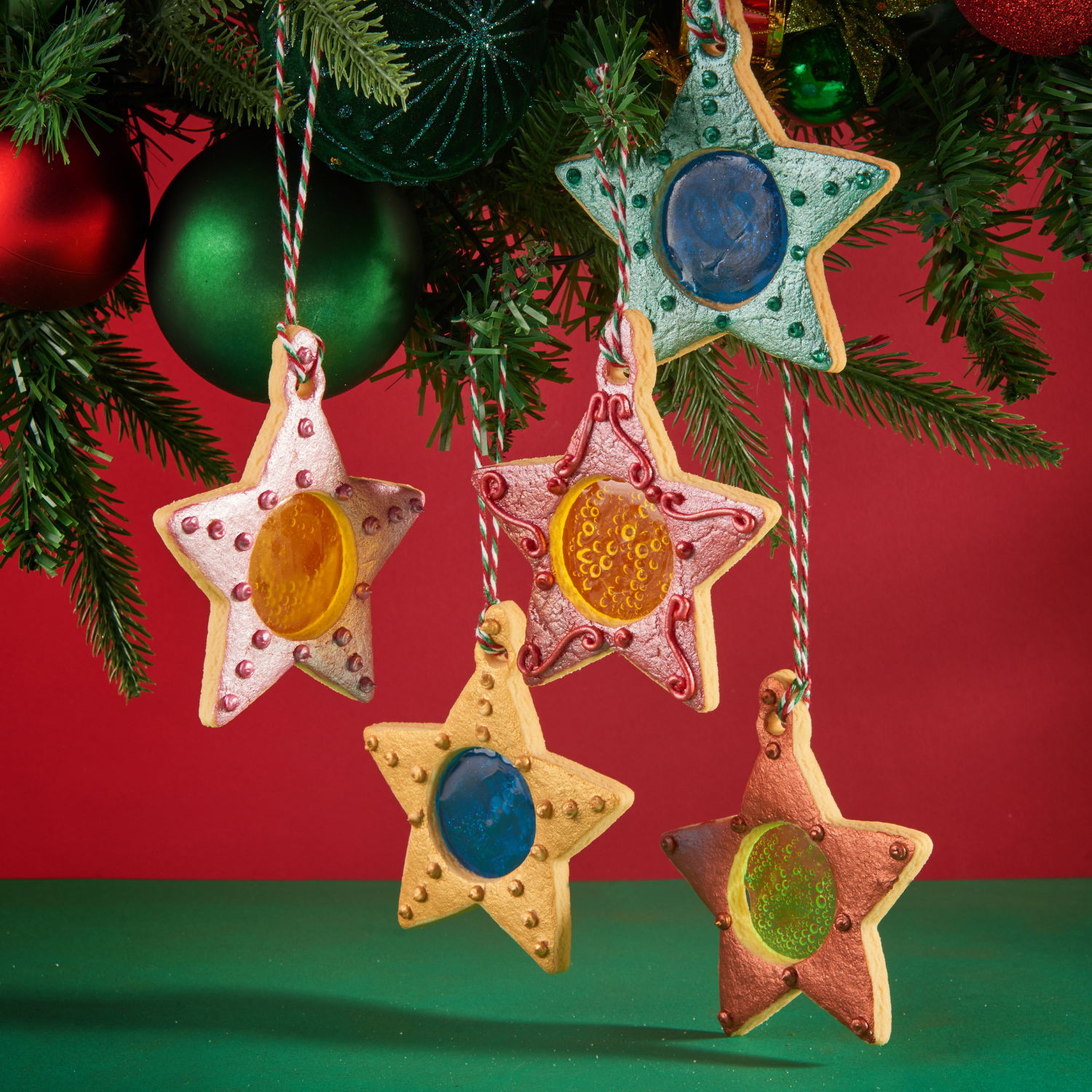 Stained glass star cookies hanging on a Christmas tree