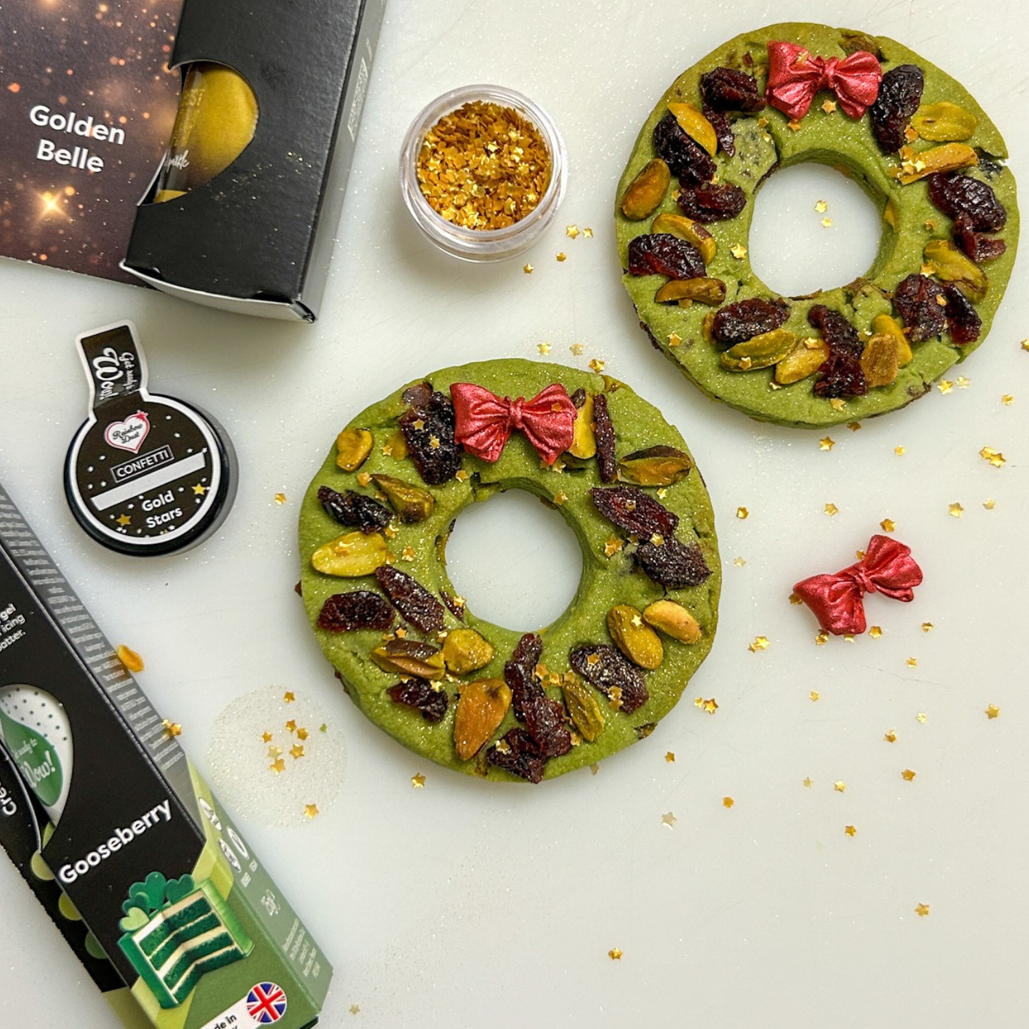 Pistachio wreath cookies topped with dried fruit, nuts and red bows