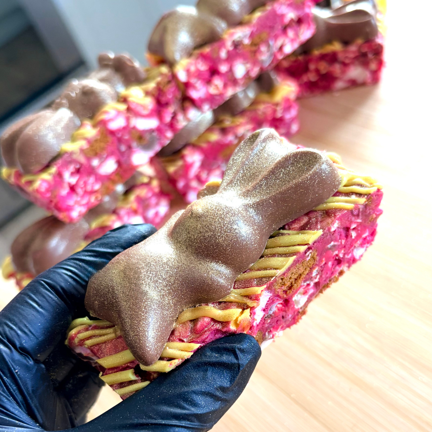 Pink rocky road slices topped with a metallic gold chocolate bunny
