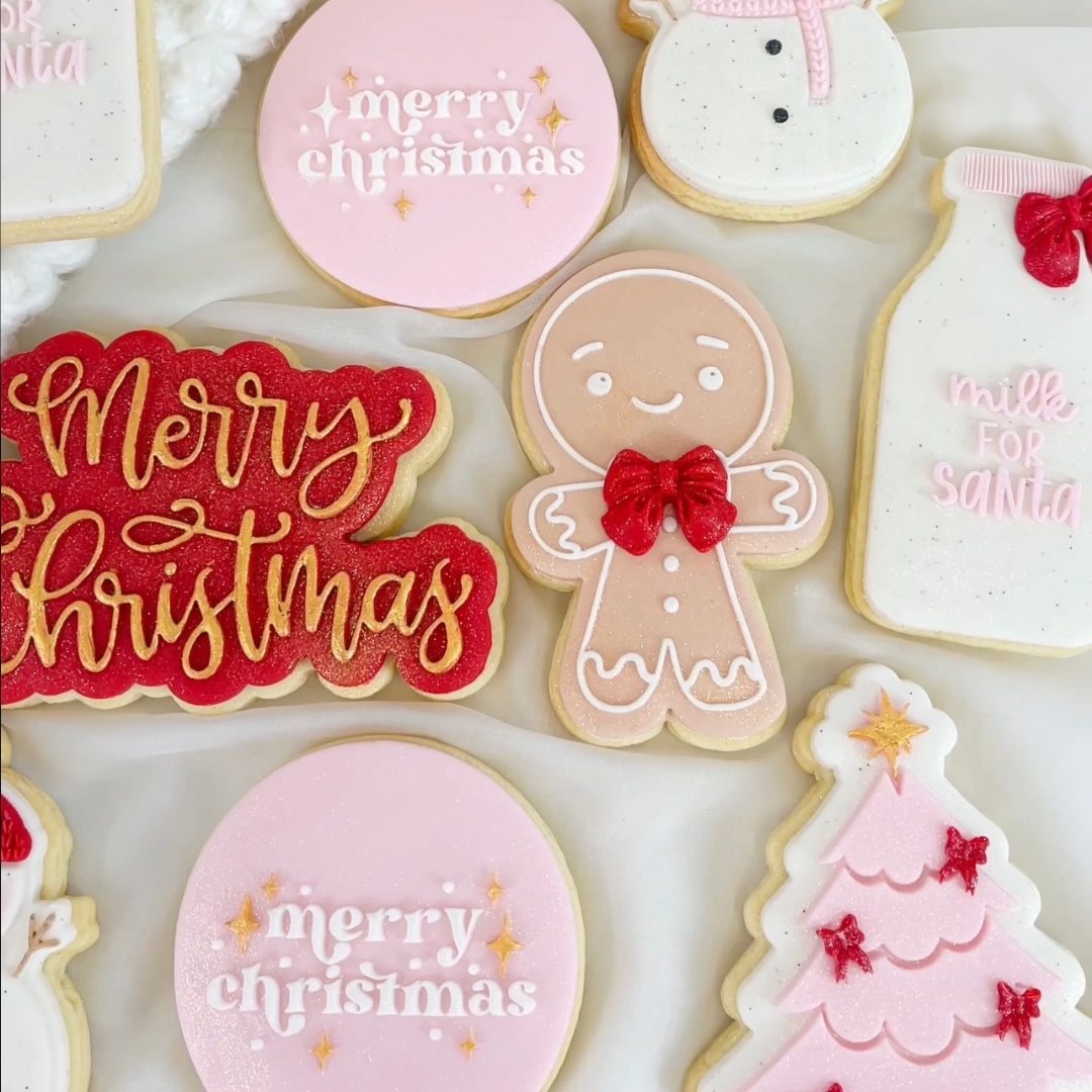 Pastel Christmas fondant cookies shaped as baubles, gingerbread people and trees