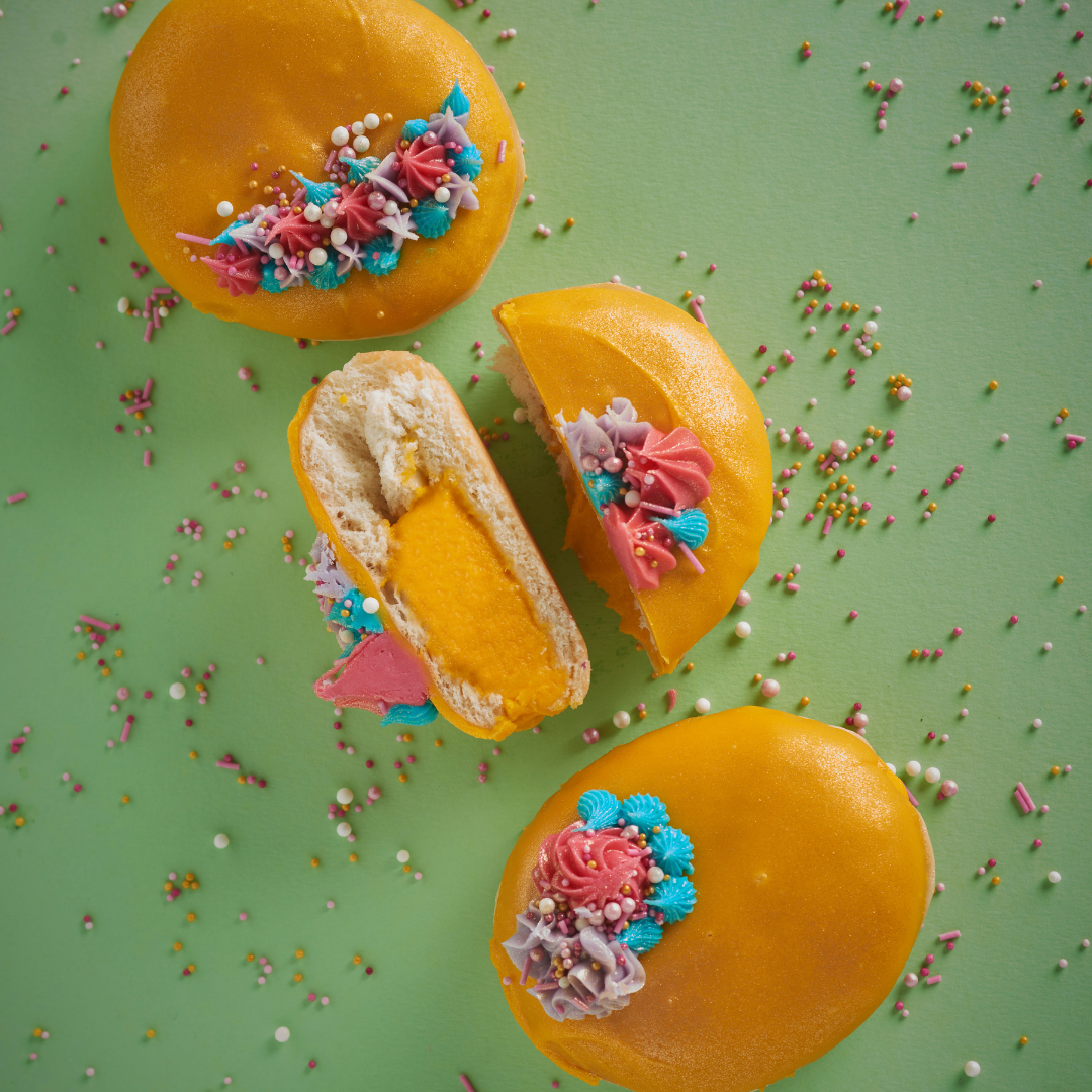 Mango-glazed doughnuts filled and topped with colourful buttercream