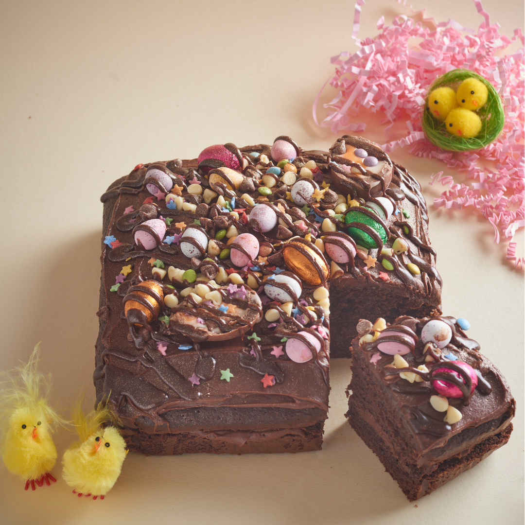 Chocolate Easter traybake topped with mini eggs, sprinkles and chocolate shards