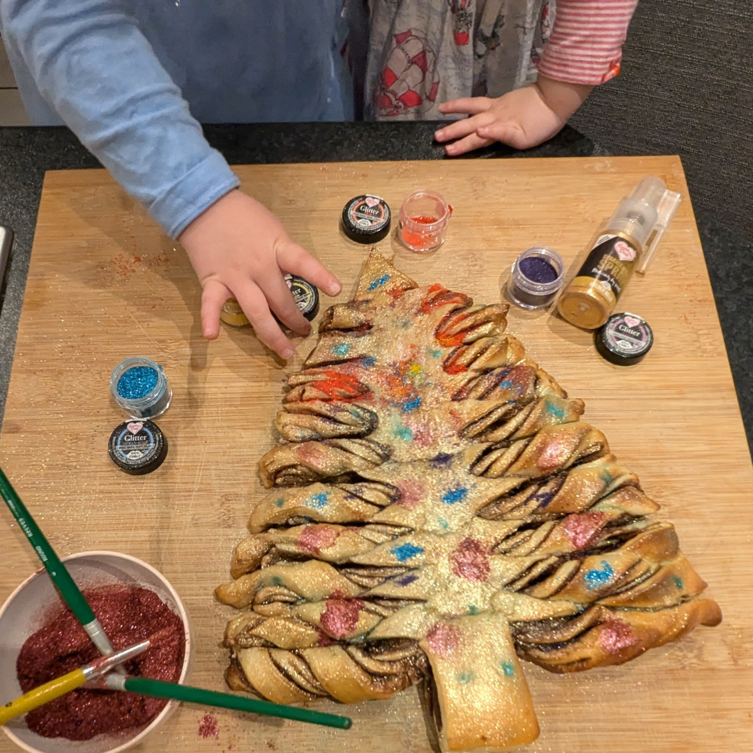 Star-shaped tear-and-share pastry being decorated with edible glitter